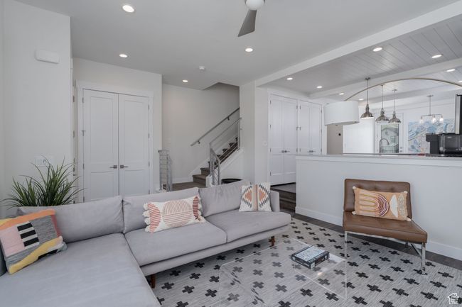 Living area featuring recessed lighting, stairway, ceiling fan, light wood finished floors, and baseboards | Image 4