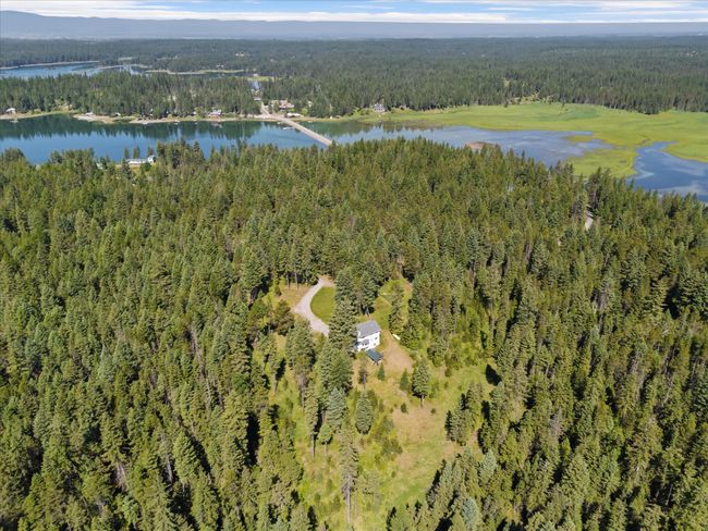 Aerial view of property and surrounding area featuring a forest and a large body of water | Image 52