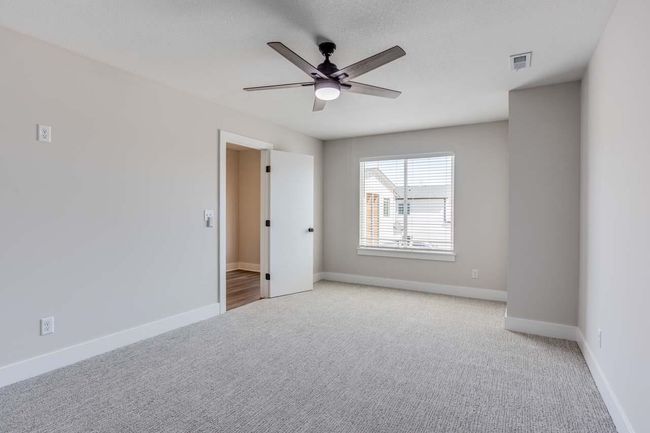 Spare room featuring light carpet, ceiling fan, and baseboards | Image 14