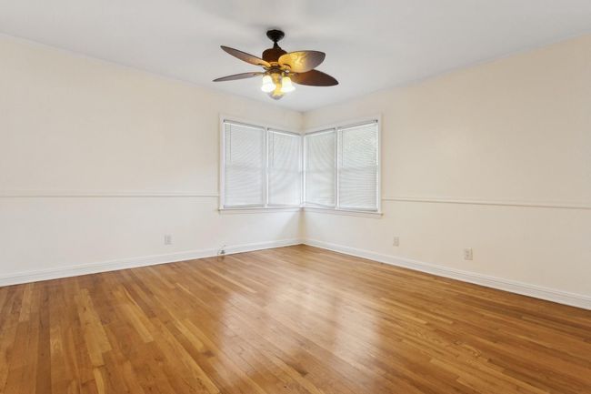 Unfurnished room featuring baseboards, light wood-style floors, and ceiling fan | Image 21