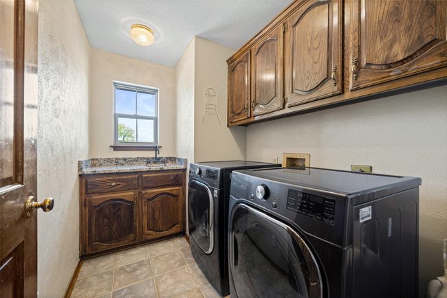 Laundry area with cabinet space and washer and clothes dryer | Image 23
