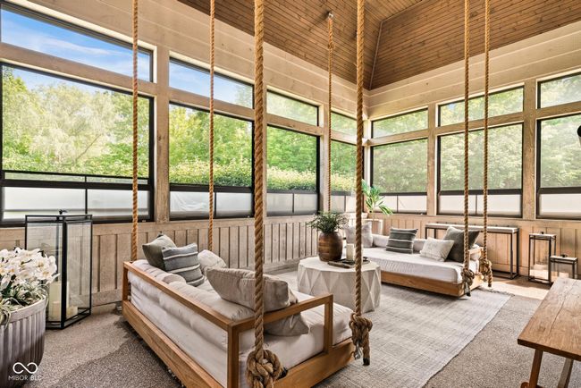 sunroom / solarium featuring vaulted ceiling | Image 46