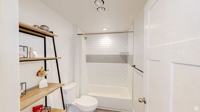 Bathroom featuring toilet and shower / bath combo with shower curtain | Image 32