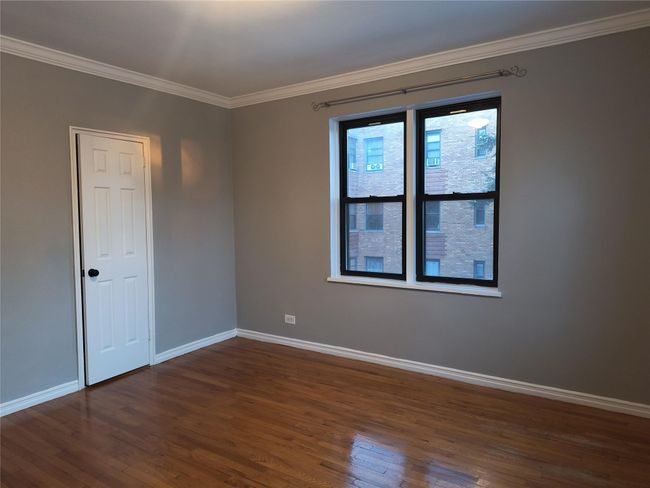 Unfurnished room with dark wood finished floors, baseboards, and ornamental molding | Image 33
