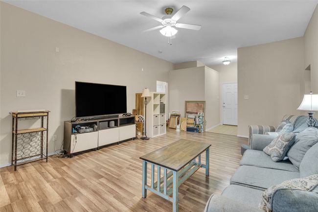 Living room with ceiling fan and light wood-type flooring | Image 4
