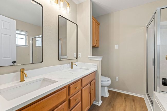Bathroom featuring a shower stall, wood finished floors, and a sink | Image 20