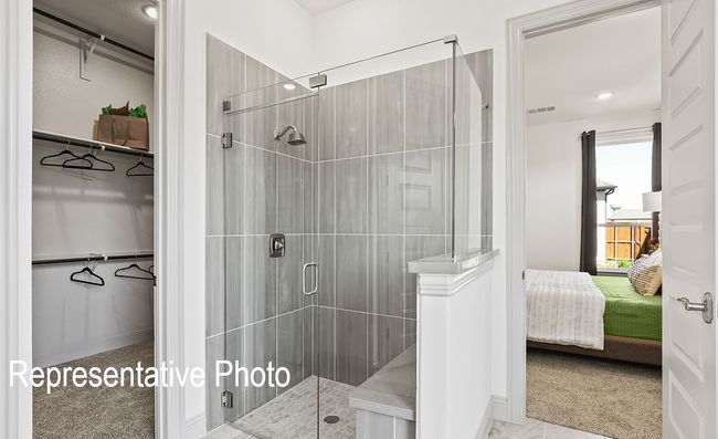 Full bathroom with a shower stall, ensuite bathroom, and a walk in closet | Image 9