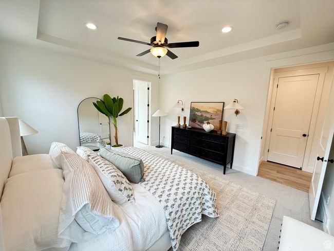 Bedroom featuring a tray ceiling, carpet flooring, baseboards, and recessed lighting | Image 15