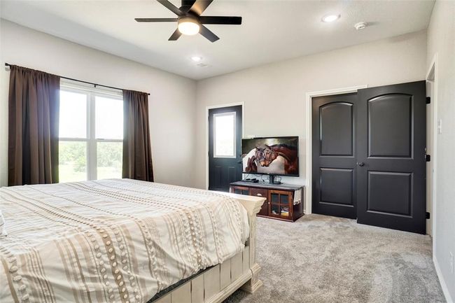 Carpeted bedroom featuring ceiling fan | Image 21