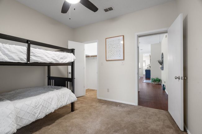 Carpeted bedroom with a walk in closet and ceiling fan | Image 21