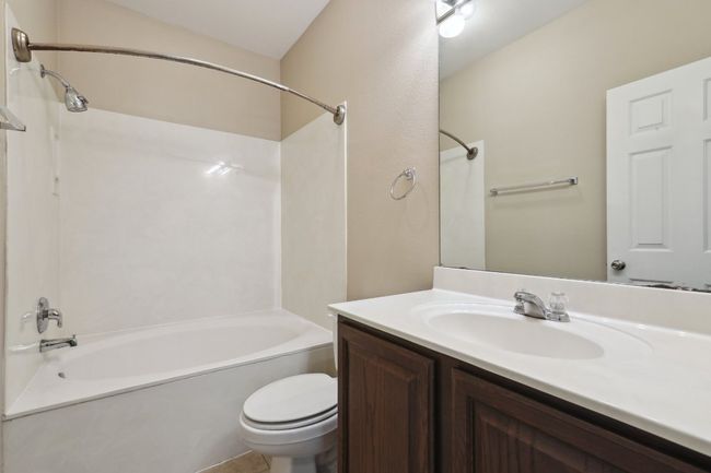 Bathroom featuring toilet, vanity, and shower / bath combination | Image 22