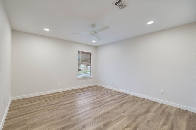 Empty room featuring visible vents, a ceiling fan, light wood-style flooring, and recessed lighting | Image 28