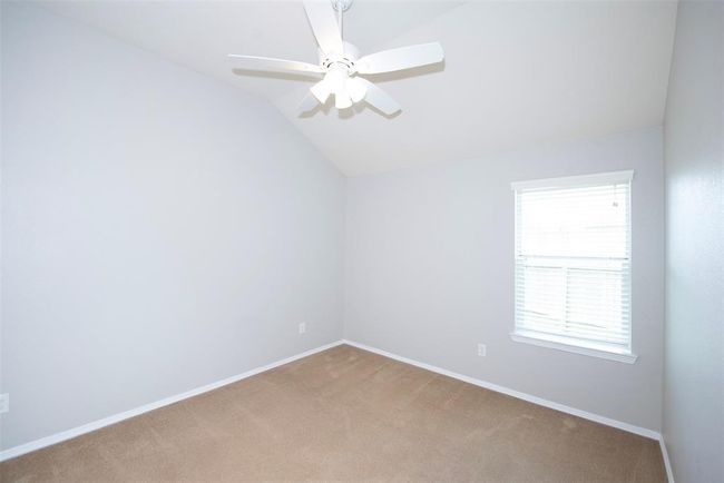 The third bedroom located along the side of the home also with great space. It too has the high vaulted ceiling. Great room for one of the kids or maybe even a home office if not needed for an extra bedroom. | Image 26