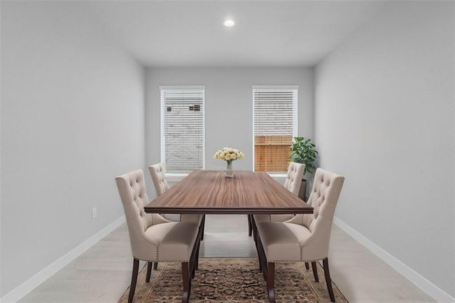 Make memories gathered around the table with your family and friends! This dining room features high ceilings, large windows with blinds, recessed lighting and gorgeous wood look tile flooring. | Image 5