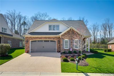 View of front of house featuring a garage and a front yard | Image 1