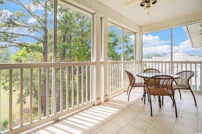 Sunroom with ceiling fan and outdoor dining area | Image 26