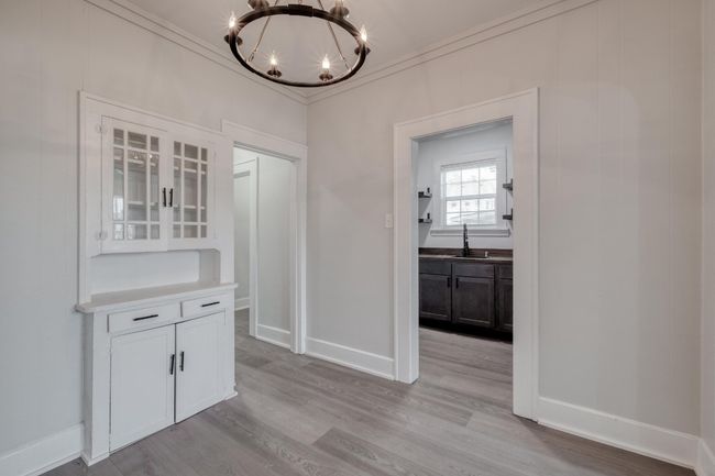 Unfurnished dining area featuring a chandelier, light wood finished floors, and ornamental molding | Image 28
