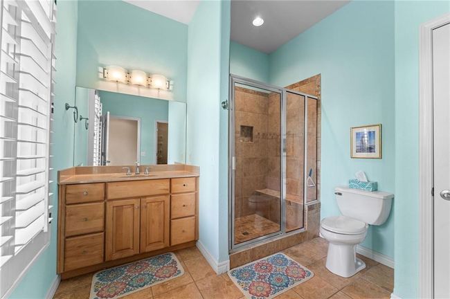 Full bath with toilet, a shower stall, vanity, and baseboards | Image 43