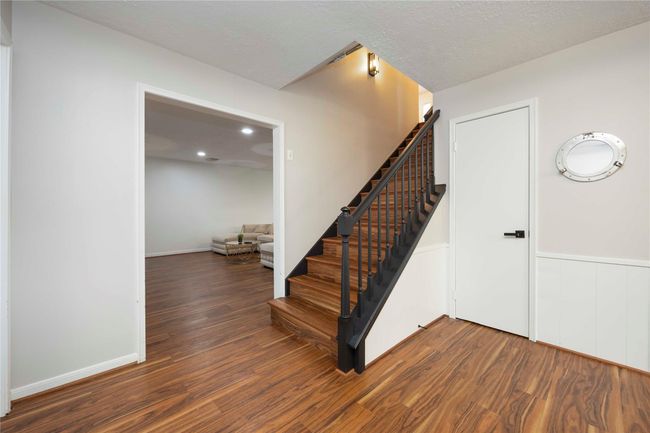 Elegant staircase with beautifully crafted railings leading to additional rooms on the second floor. | Image 22