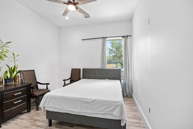 Bedroom featuring light wood-style floors, recessed lighting, and ceiling fan | Image 23