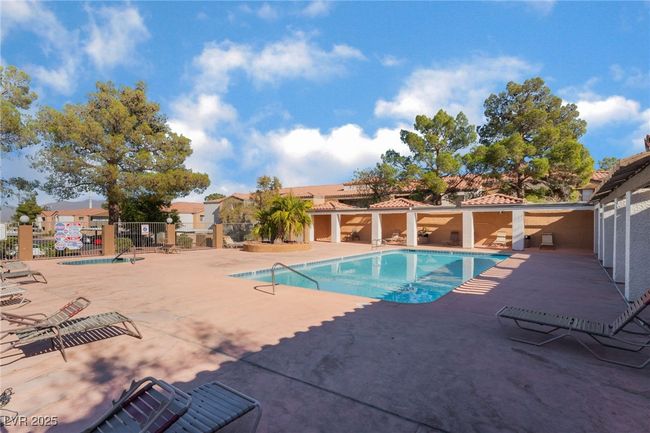 Community pool with a patio area | Image 41
