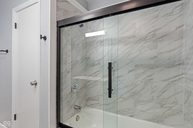 bathroom featuring enclosed tub / shower combo | Image 25