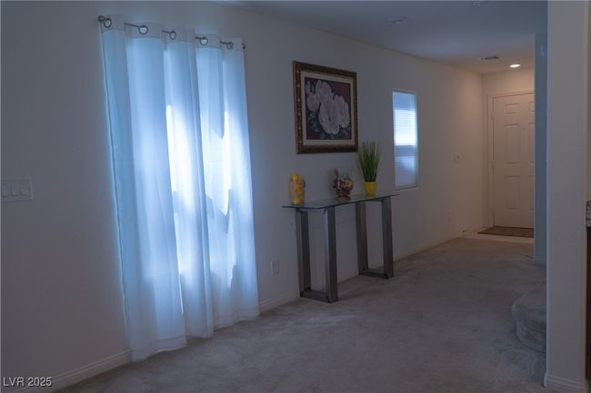 Corridor with visible vents, baseboards, and light colored carpet | Image 12