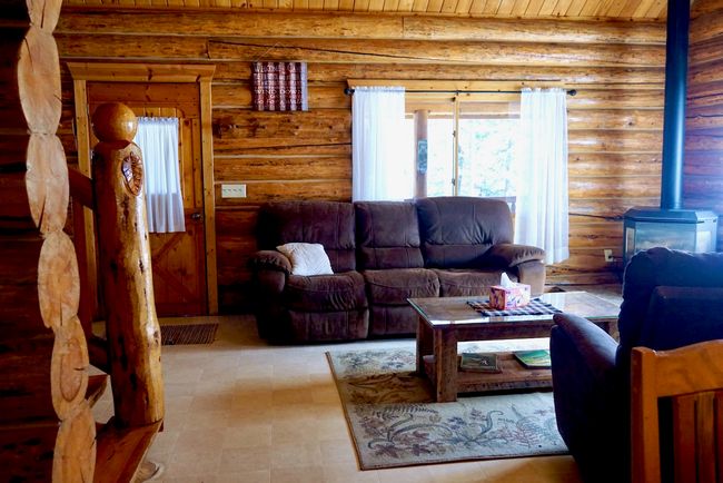 Living area featuring wooden ceiling and a wood stove | Image 35