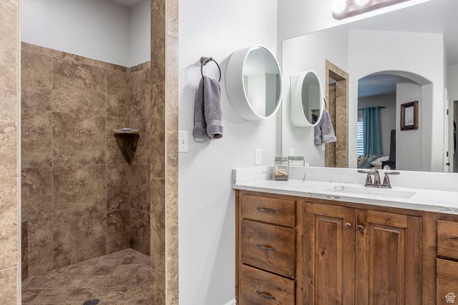 Bathroom featuring vanity and tiled shower | Image 19