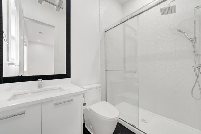 Full bath with toilet, a shower stall, vanity, and tile patterned floors | Image 12