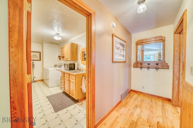 Hall leading to laundry on left, primary bedroom on right | Image 27