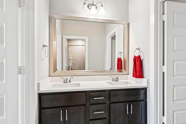 Bathroom with double vanity and a shower with shower curtain | Image 25