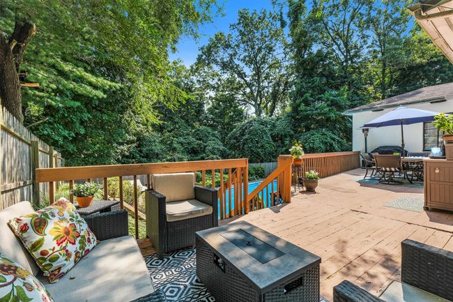Wooden terrace featuring an outdoor living space, outdoor dining space, and fence | Image 42