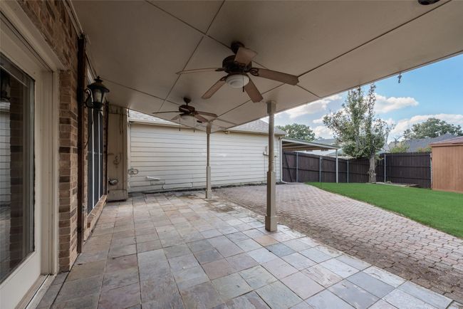 Fenced backyard with a patio and a ceiling fan | Image 25
