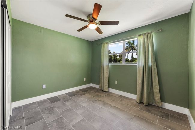 Tiled empty room featuring ceiling fan | Image 32