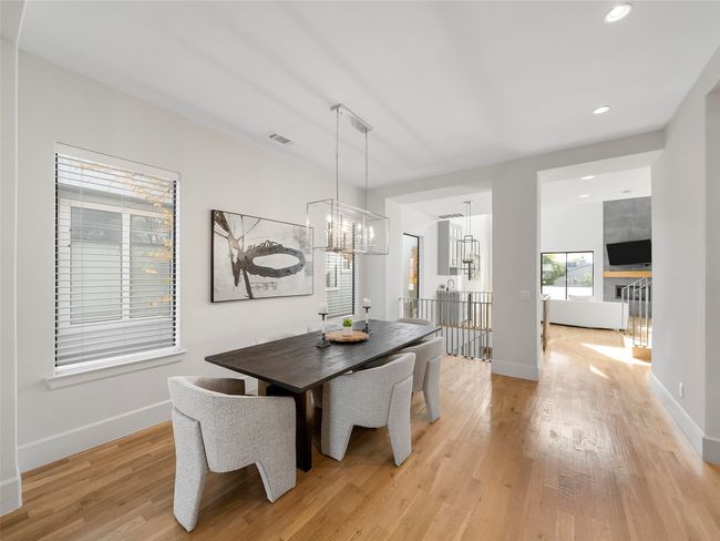 Dining area with light wood-style flooring, recessed lighting, and a chandelier | Image 15