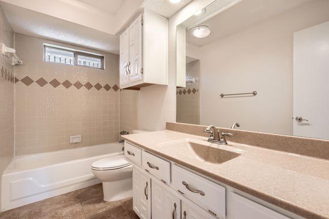 Bathroom featuring vanity and shower / tub combination | Image 19