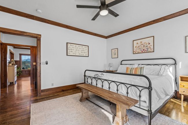 Bedroom featuring crown molding, dark hardwood / wood-style floors, and ceiling fan | Image 19