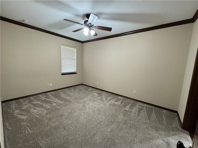 Unfurnished room featuring crown molding, carpet, and a ceiling fan | Image 7