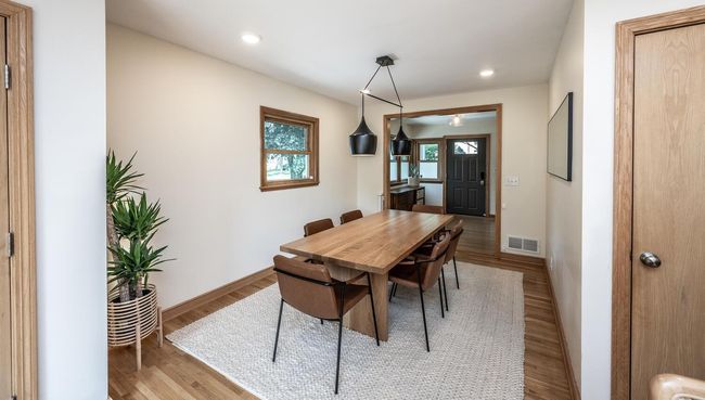 Informal dining room with hardwood floors- view from kitchen toward front door. | Image 12