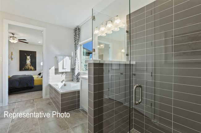 Ensuite bathroom featuring a shower stall, a garden tub, ensuite bathroom, ceiling fan, and tile patterned flooring | Image 11
