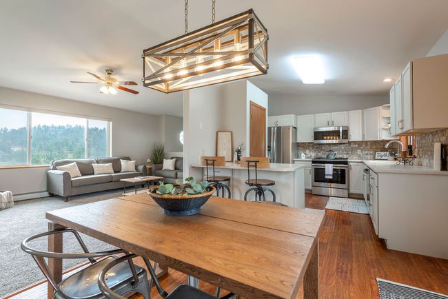 Dining area featuring a ceiling fan, lofted ceiling, and dark wood finished floors | Image 6