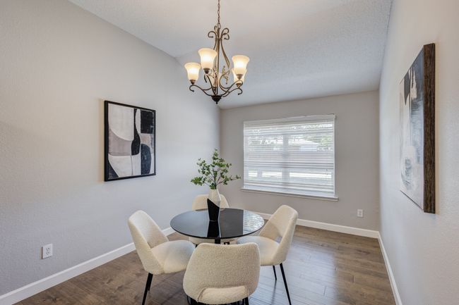 Dining area featuring a chandelier, baseboards, and dark wood-style flooring | Image 14