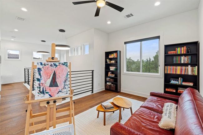 Living room with healthy amount of natural light, wood finished floors, baseboards, ceiling fan, and recessed lighting | Image 23