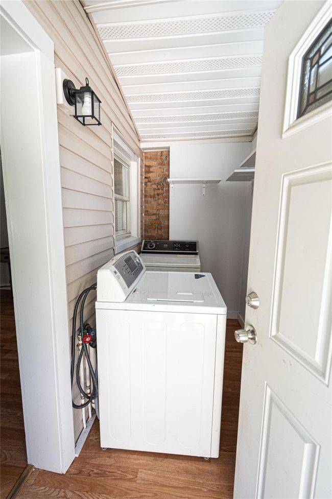 Laundry area featuring independent washer and dryer and light wood finished floors | Image 4