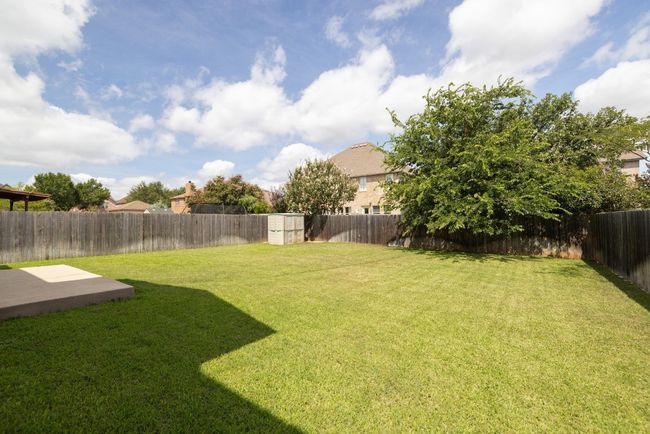 Fenced backyard featuring a shed and a patio | Image 34