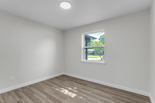 Empty room with baseboards and wood finished floors | Image 16