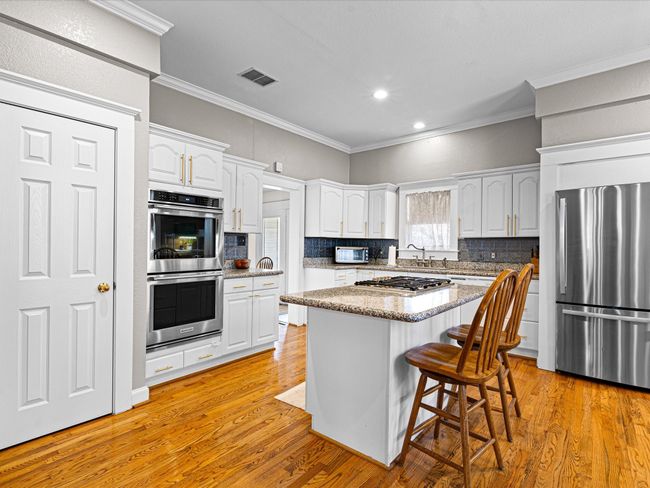 Beautifully updated cabinets, counters, floors and appliances! | Image 12