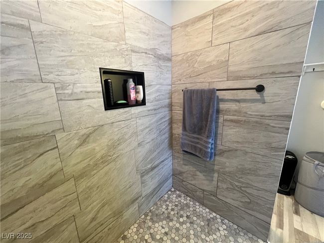 Bathroom featuring a tile shower | Image 40