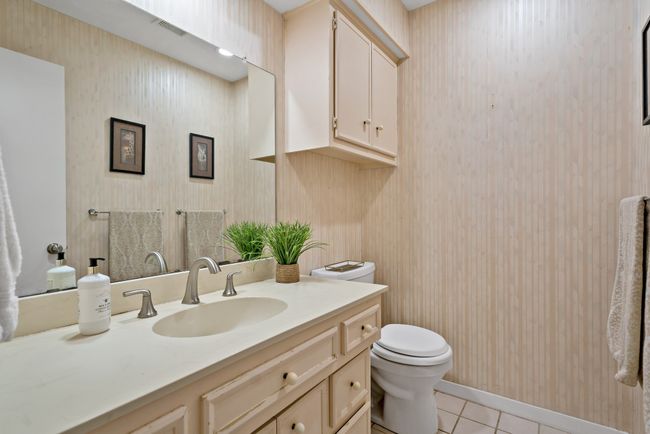 Half-Bathroom featuring tile floors, vanity, and toilet | Image 21